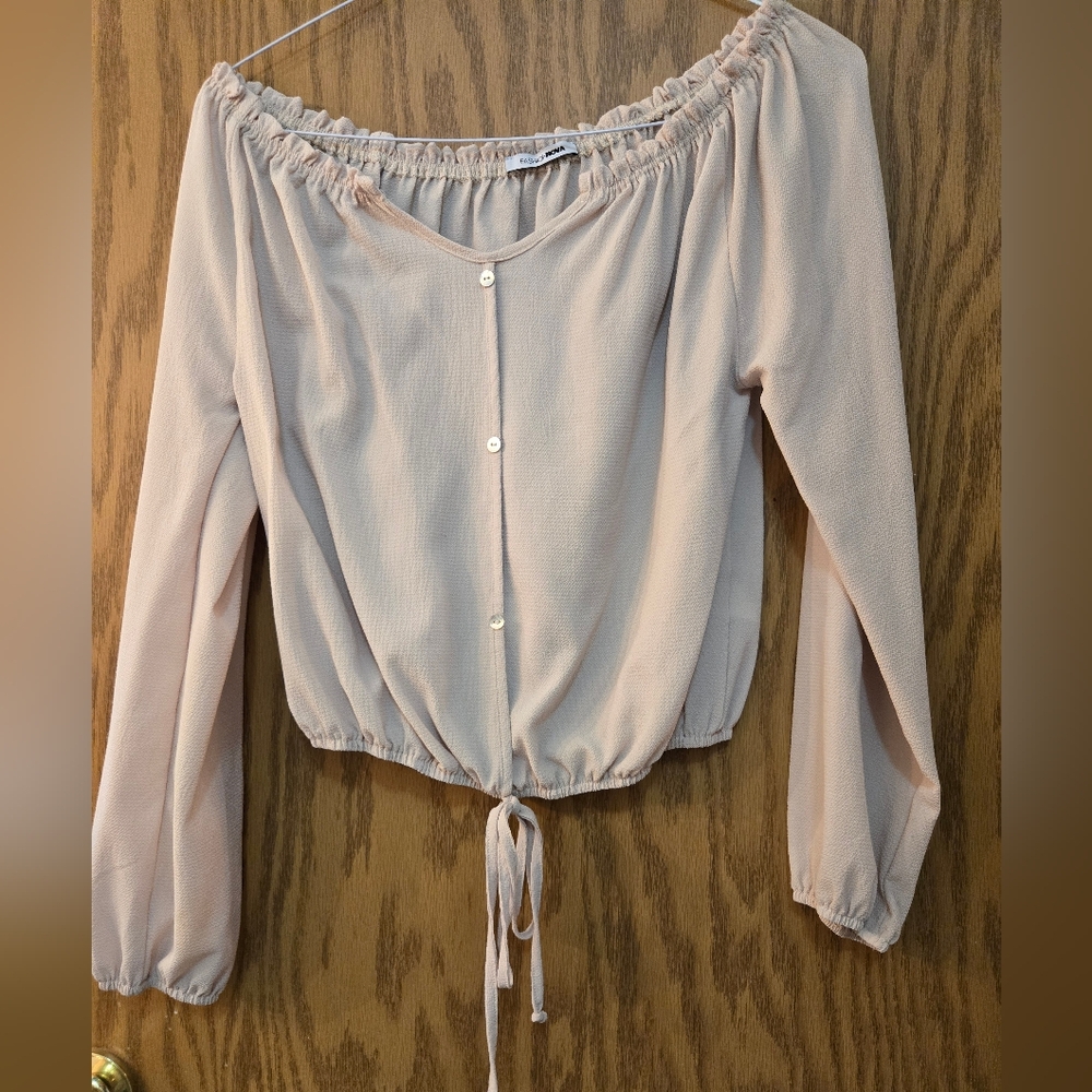 Pretty light tan, long sleeve peasant blouse with elastic waist and at wrists.